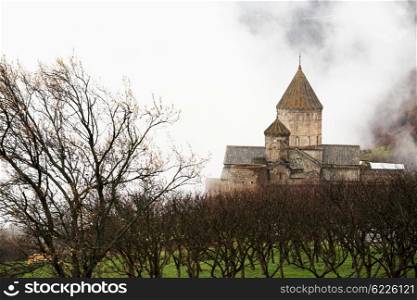 Ancient monastery Tatev covered with clouds in the mountains of Armenia. Was founded in year 906.