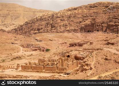 Ancient Nabataean Royal tombs in the background and ruins of grand temple in the foreground, Petra, Jordan