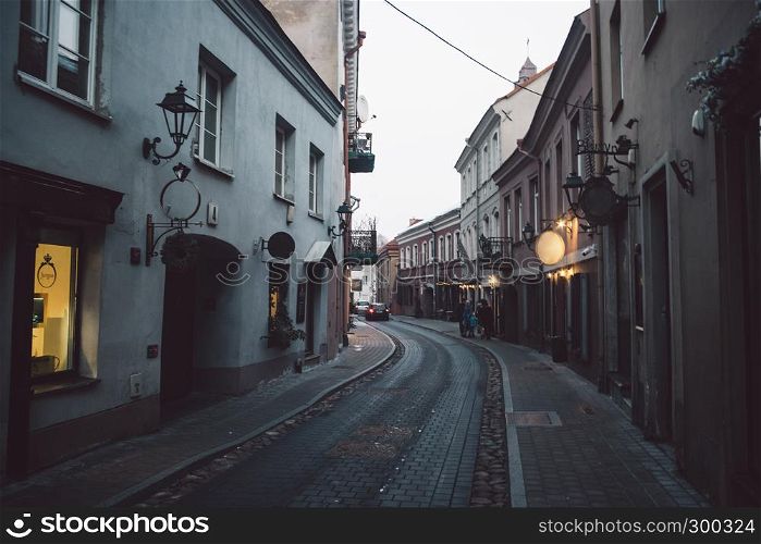 Ancient narrow Vilnius street with old architecture and winter background