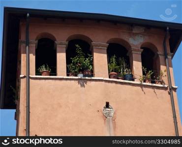 Ancient orange or ochre tower in Verona