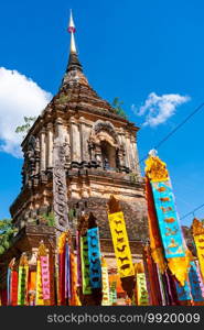 Ancient pagoda with the zodiac flags at Wat Lok Molee in Chiang Mai province Thailand.