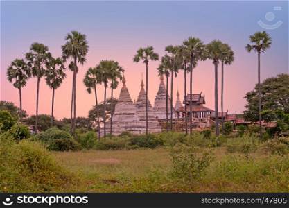 Ancient pagodas in the countryside from Bagan in Myanmar at sunset