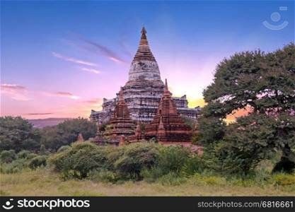 Ancient pagodas in the countryside from Bagan in Myanmar at sunset