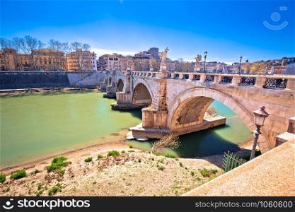 Ancient Ponte Sant Angelo stone bridge on Tiber river of Rome, capital of Italy