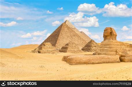 Ancient pyramids and Sphinx in the desert of Giza, Egypt. Ancient pyramids and Sphinx