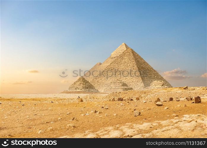 Ancient pyramids in desert of Cairo at sunset. Ancient pyramids in Cairo