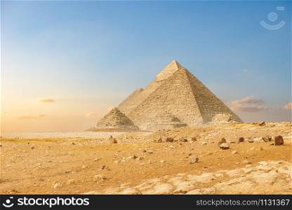 Ancient pyramids in desert of Cairo at sunset. Ancient pyramids in Cairo