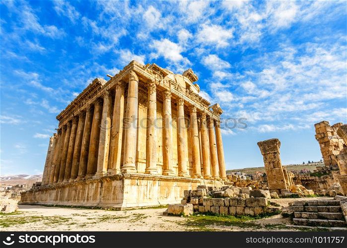 Ancient Roman temple of Bacchus with surrounding ruins with blue sky in the background, Bekaa Valley, Baalbek, Lebanon