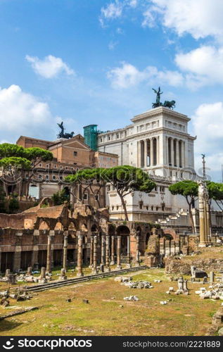 Ancient ruins of Forum and Victor Emmanuel II monument in a summer day in Rome, Italy