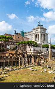 Ancient ruins of Forum and Victor Emmanuel II monument in a summer day in Rome, Italy