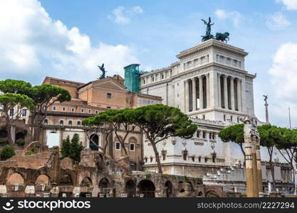 Ancient ruins of Forum and Victor Emmanuel II monument in a summer day in Rome, Italy