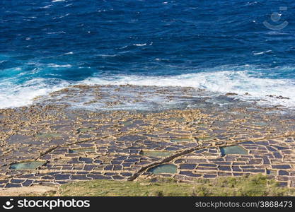 ancient salt in Qbajjar island of Gozo are still used for the production of sea salt