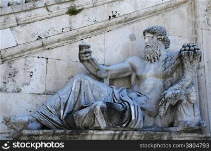 Ancient statue of the Nile river god in front of the Senatorial Palace staircase on the Capitoline Hill in Rome, Italy