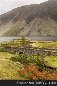 Ancient stone bridge over river running into Wastwater in Lake District