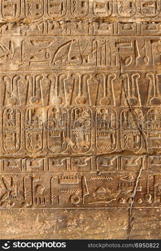 Ancient stone column with Egyptian hieroglyphs in the Karnak Temple, Luxor, Egypt