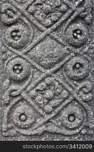 Ancient stone decorated with celtic motives, on Iona Isle, Scotland