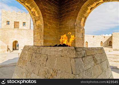 Ancient stone temple of Atashgah with burning flame inside, Zoroastrian place of fire worship, Baku, Azerbaijan