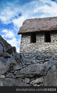 ancient stone wall and house in Machu Picchu