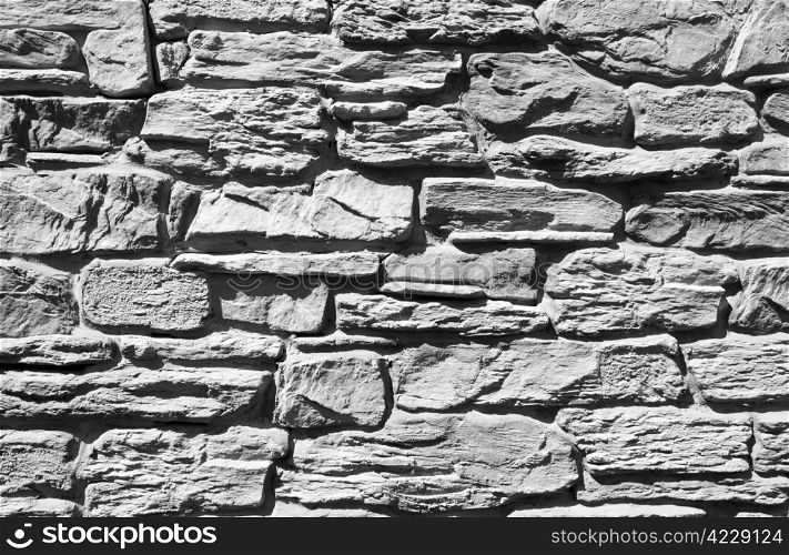 Ancient stones. Weathered black and white wall