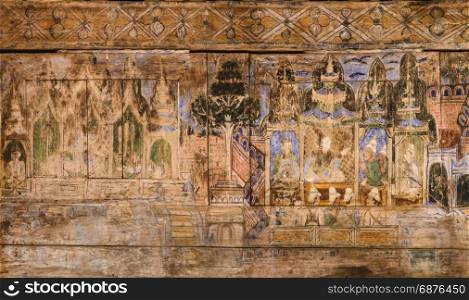 Ancient Thai mural painting on wooden temple wall in Lampang, Thailand