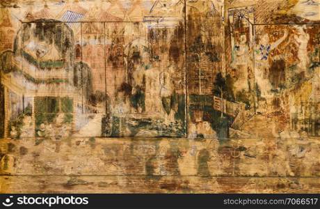 Ancient Thai mural painting on wooden temple wall in Lampang, Thailand