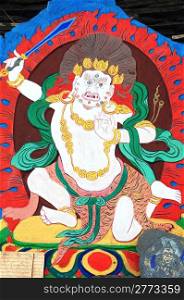 Ancient Tibetan wall painting art of buddha in a historic Tibetan lamasery