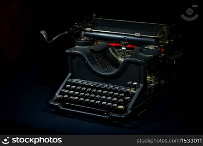 Ancient typewriter on a black background