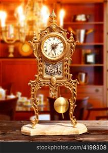 ancient vintage brass pendulum clock in classic indoor