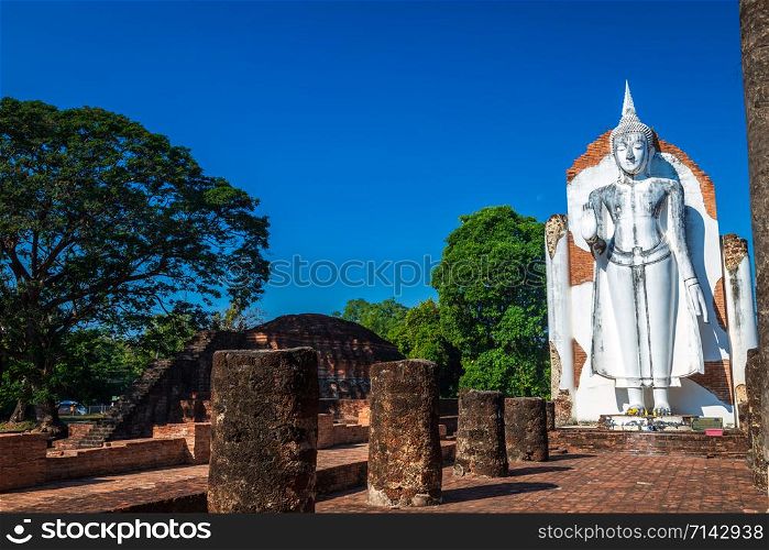 Ancient white buddha statue beautiful at sunset is a Buddhist temple It is a major tourist attraction in Phitsanulok, Thailand.