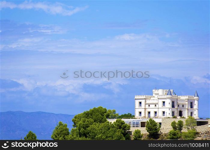 Ancient white castle located at the top of a mountain. White castle at the top of a mountain