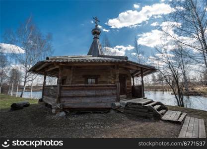 Ancient wooden chapel stands on the banks of the river. Kostroma, Russia