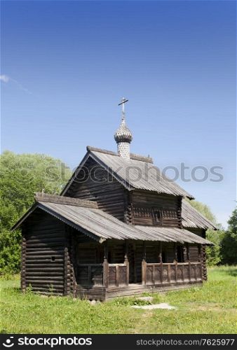 Ancient wooden church on a forest glade. Russia.