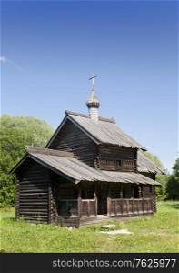 Ancient wooden church on a forest glade. Russia.