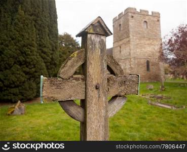 Ancient wooden cross in cemetery of old parish church of Stokesay in Shropshire