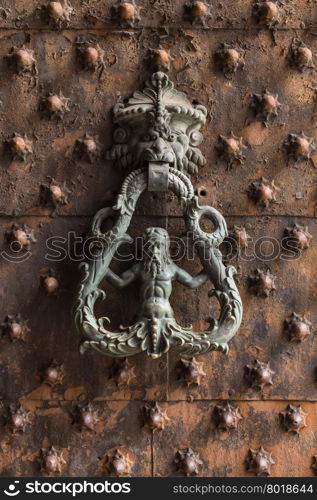 Ancient wooden spiked door detail in Genoa, Italy