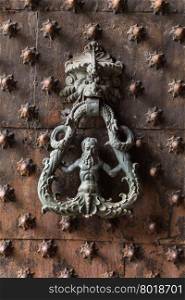 Ancient wooden spiked door detail in Genoa, Italy