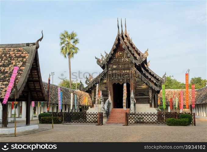Ancient wooden teak temple of Lanna architecture with fine woodcarvings and gilded stuccos