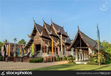 Ancient wooden teak temple of Lanna architecture with fine woodcarvings and gilded stuccos