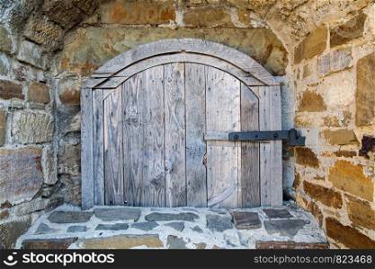 Ancient wooden window of medieval brick wall. Old window of medieval brick wall