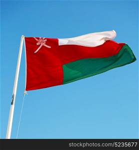 and the cloudy sky in oman waving flag