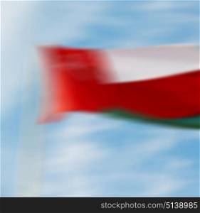 and the cloudy sky in oman waving flag blurred