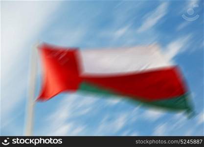 and the cloudy sky in oman waving flag blurred