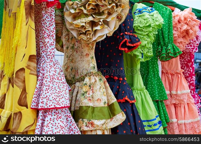 Andalusian gipsy dresses in a row at Spain outdoor market