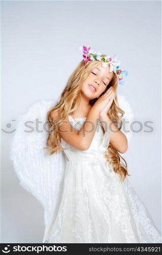 Angel children blond girl with sleeping hands gesture and fashion crown