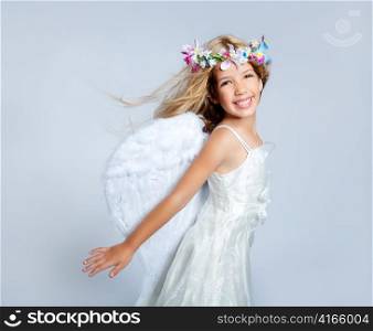Angel children girl with wind in hair fashion white wings and flowers crown