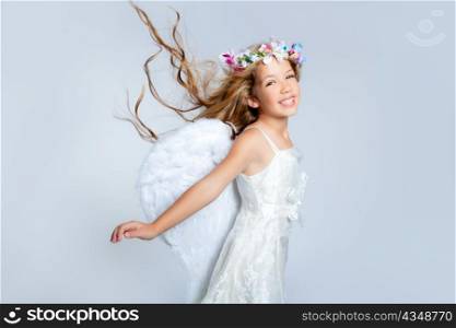 Angel children girl with wind in hair fashion white wings and flowers crown