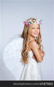 Angel children little girl portrait with fashion white wings and flowers crown