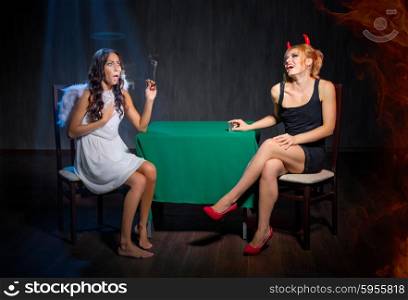 Angel with cigar and devil on dark background