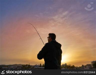 Angler with spinning rod fishing in Mediterranean. Angler with spinning rod fishing in Mediterranean sea of Javea Spain