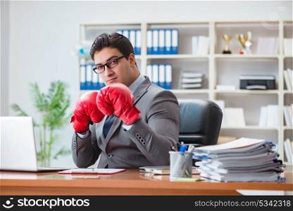 Angry aggressive businessman with boxing gloves